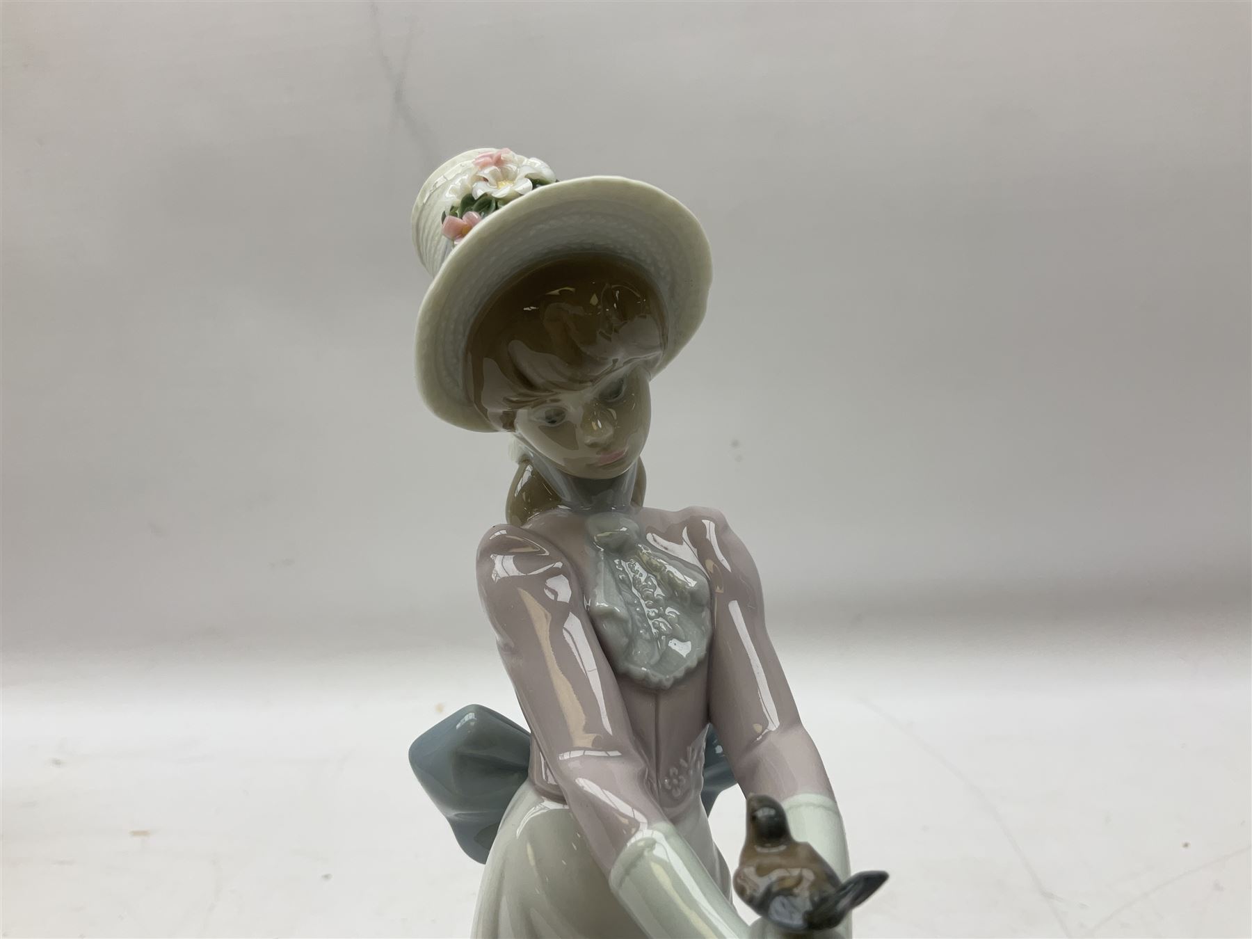 Two Lladro figures, comprising Garden Classic, no 7617 and Garden Song, no 7618, with original boxes and artists signature beneath, largest example H23cm