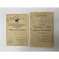 Three German documents dated 1942 - Gold Cross award to Major Ludwig Osterkampf; and Crete wound certificate and cuff title certificate awarded to Feldwebel Alfred Glaise; all unframed (3)
