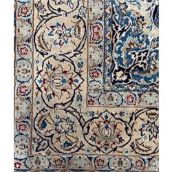 Central Persian Nain carpet, the deep blue field with finely drawn scrolling palmettes and flowering vines around a central ivory and sky blue rosette medallion, enclosed by an ivory border of interlaced floral arabesques and lotus forms between multiple guard stripes, from the region of Nain
