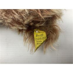 Steiff teddy bear with golden plush body, revolving head, applied eyes, vertically stitched nose and mouth and jointed limbs; button to left ear H26cm; and two other Steiff teddy bears, each with open mouth and button with tag to left ear (3)
