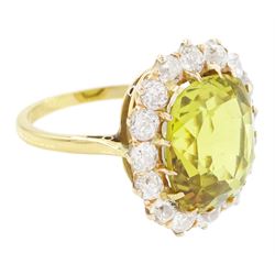 Early 20th century gold chrysoberyl and diamond cluster ring, single cushion cut yellow / green chrysoberyl of approx 8.00 carat, surrounded by sixteen old cut diamonds, stamped 18ct, total diamond weight approx 1.10 carat