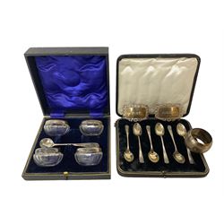 Cased set of six spoons by Cooper Brothers & Sons, two hallmarked silver decanter labels, four silver collared glass salts in box, further silver spoon and napkin ring