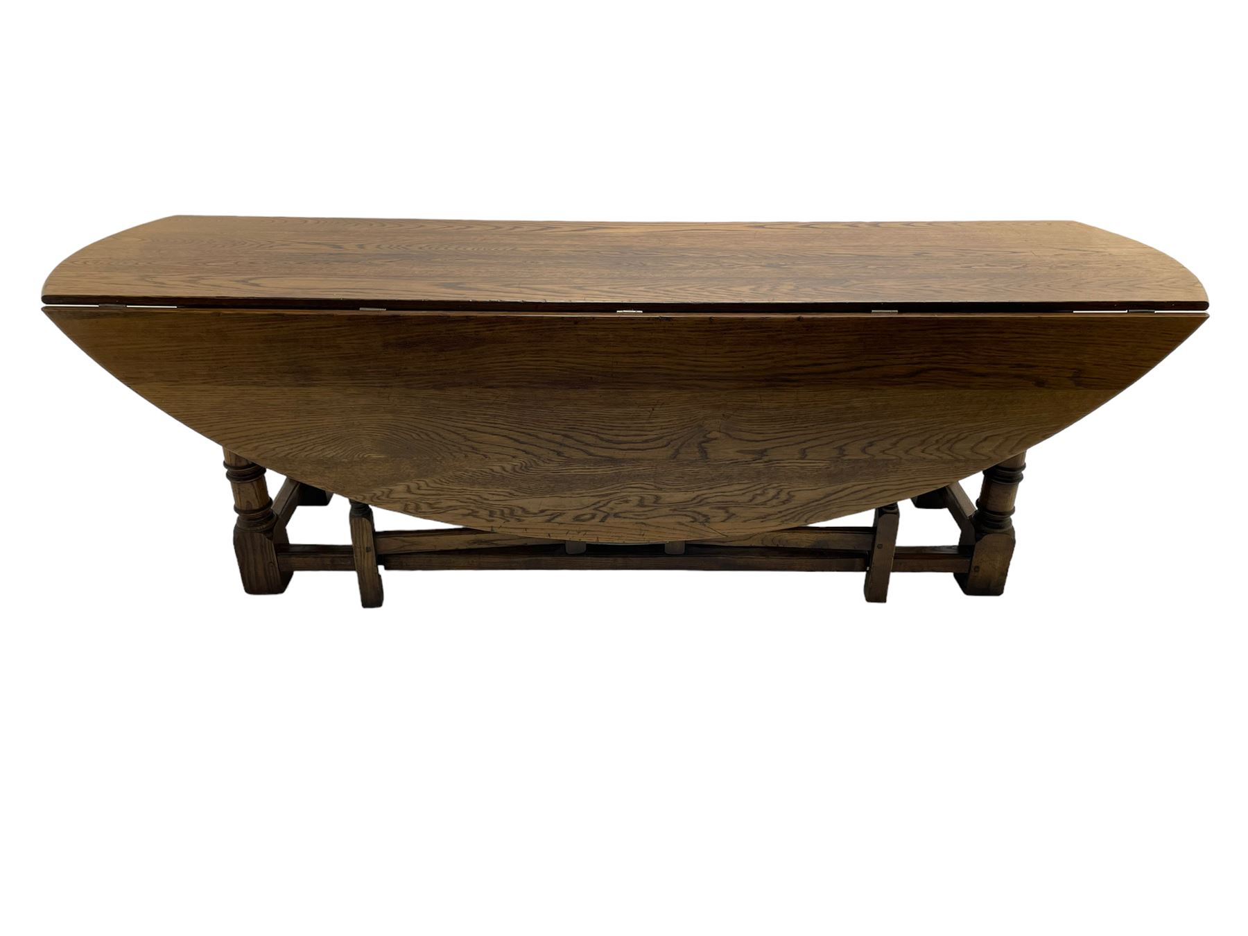 Large 18th century design oak wake or dining table, oval drop-leaf top, turned supports with double gate-leg action base, united by moulded stretchers 