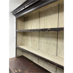 Early 19th century scumbled pine dresser, the projecting cornice over two heights plate rack with moulded frame, the base with reeded canted corners fitted with three drawers and two panelled cupboards, panelled sides, moulded skirt base