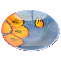 Three Poole pottery chargers, in Wild Poppy pattern, Delphis pattern and Aegean pattern, together with a Poole pottery dish and plate  