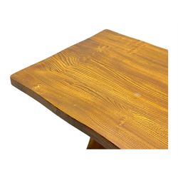 Late 20th century oak trestle table, rectangular top with naturalistic edge, supported by two curved pedestal bases united by central stretcher, on block feet