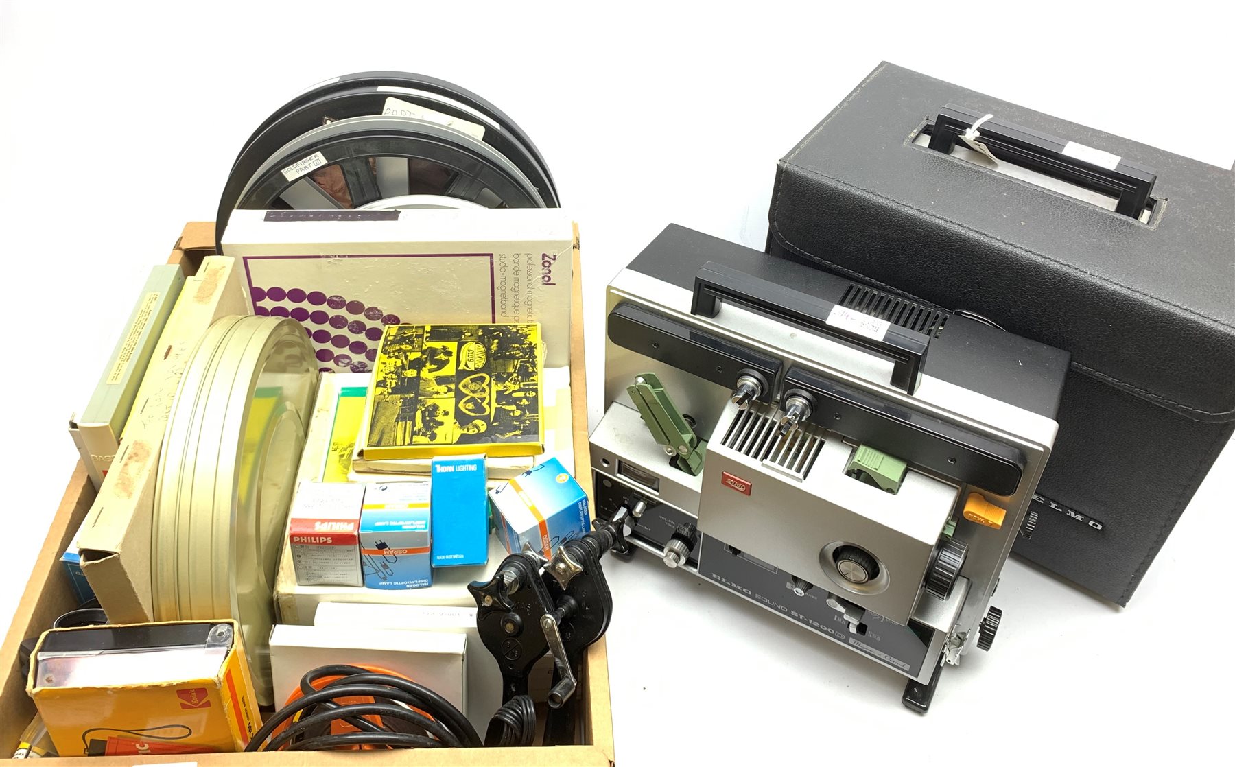 Two 'ELMO Sound ST-1200D' super 8 sound projectors, one in a carry case with photocopy of the original instruction manual, together with various film reels, spare bulbs and other accessories