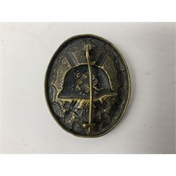 Two German WW2 wound badges - 'silver' in original box, numbered verso L22; and black on brass (2)