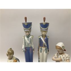 Lladro figures, comprising soldier with sword H30.5cm, soldier with gun H30.5cm and girl with basket of oranges, H17.5cm, together with Bing & Grondahl porcelain figure of a girl with a doll. 