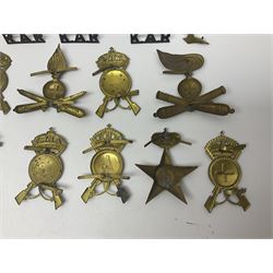 Over thirty British and Continental military metal badges; together with quantity of shoulder titles, collar dogs, rank pips, uniform buttons etc
