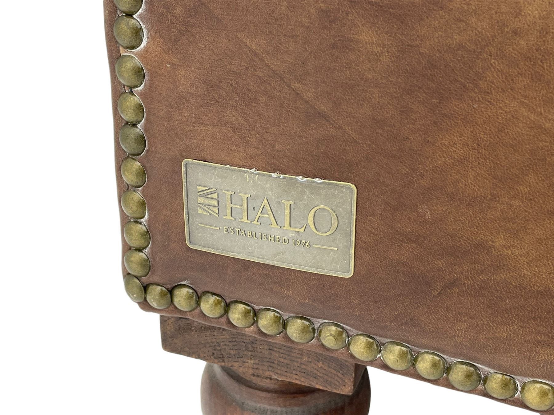 HALO - Chesterfield style two seat sofa upholstered in buttoned brown leather with stud work, on turned feet with castors