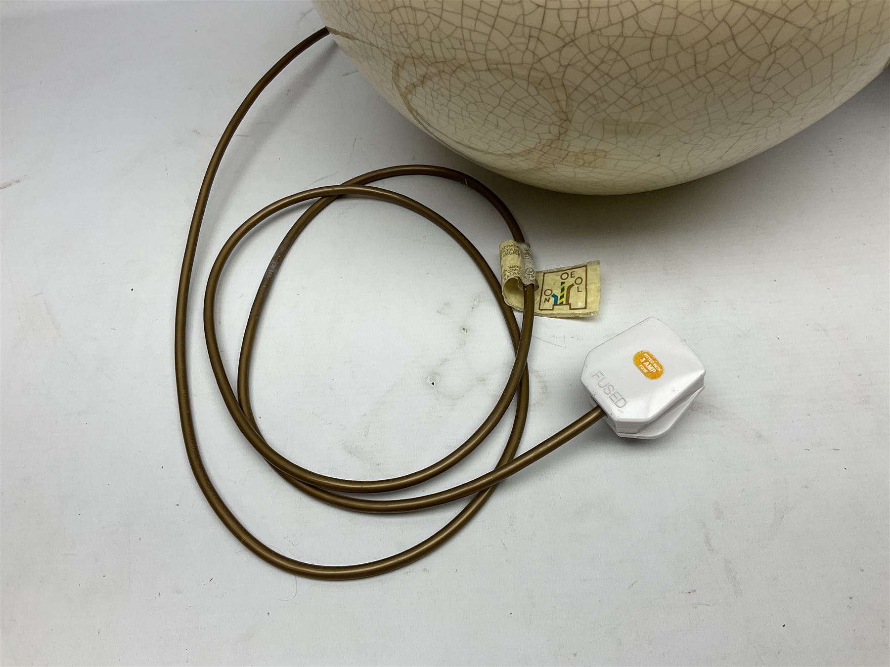 Large cream crackle glaze table lamp, together with a tall studio pottery vase in green with single loop handle, with impressed makers mark, H49cm