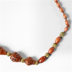 Chinese Hediao necklace, comprising twenty-one pierced and carved seeds strung with smaller beads, the carvings depicting birds among foliage, crabs and fish, figures and warriors, and other traditional scenes, length 82cm 