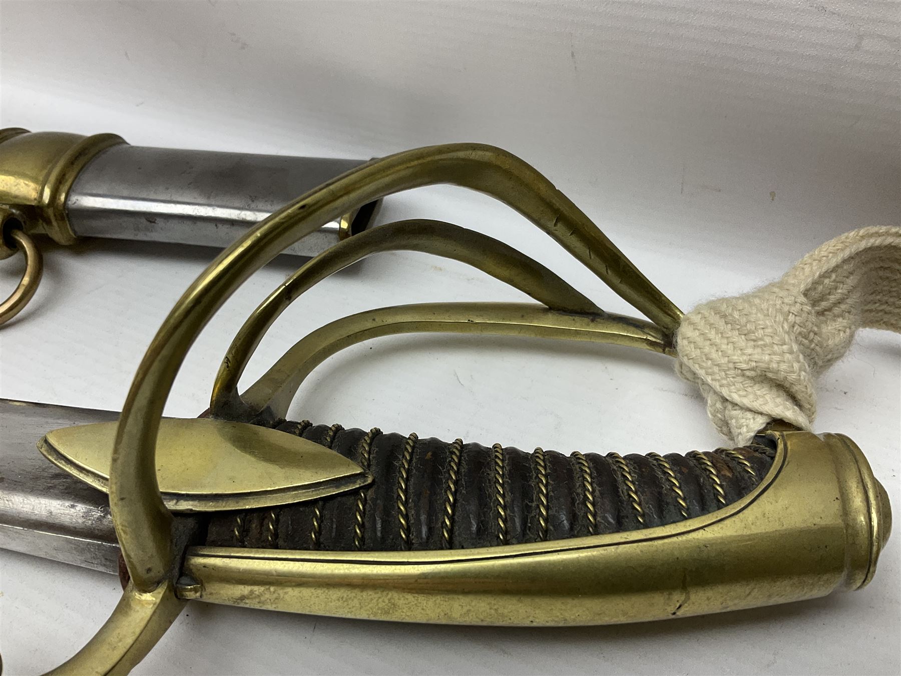 19th century French Chasseur a Cheval de la Guard trooper's sword with 86.5cm slightly curving fullered blade, brass three-bar hilt with elongated elliptical langets and wire-bound leather grip; in polished steel scabbard with two brass suspension rings L104cm overall
