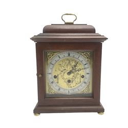 Hermle - German 8-day 20th century quarter chiming mantle clock , in a mahogany case with a moulded top and carrying  handle,  square brass dial with a silvered chapter ring and cast brass spandrels, with a floating balance escapement chiming the quarters and hours on 5 gong rods. With key.