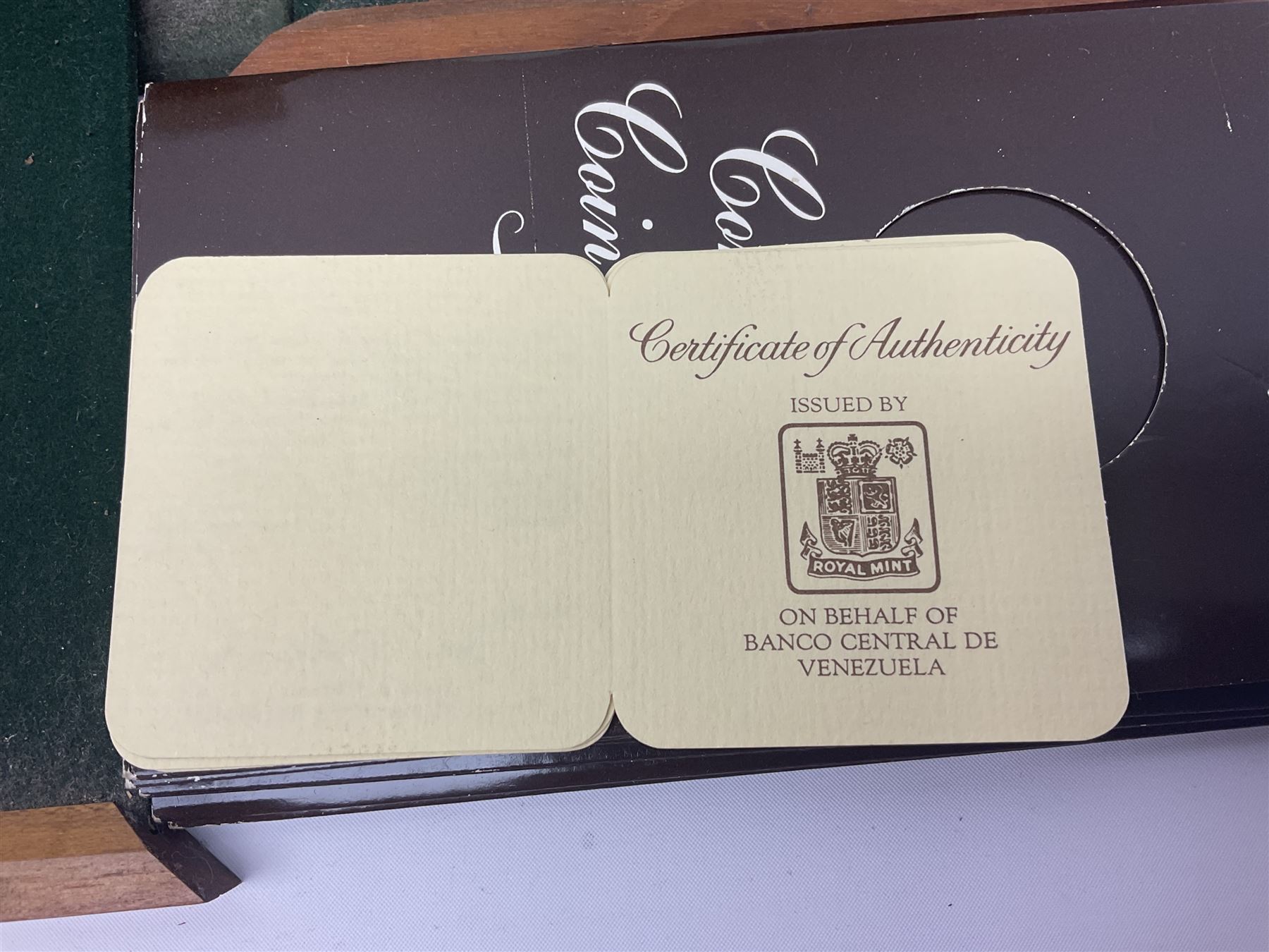 The Royal Mint 'Conservation Coin Collection' formed of twenty-four silver proof coins, housed in the wooden display case, with information booklet