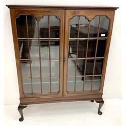Early 20th century display cabinet enclosed by two astragal glazed doors, three adjustable shelves, cabriole legs