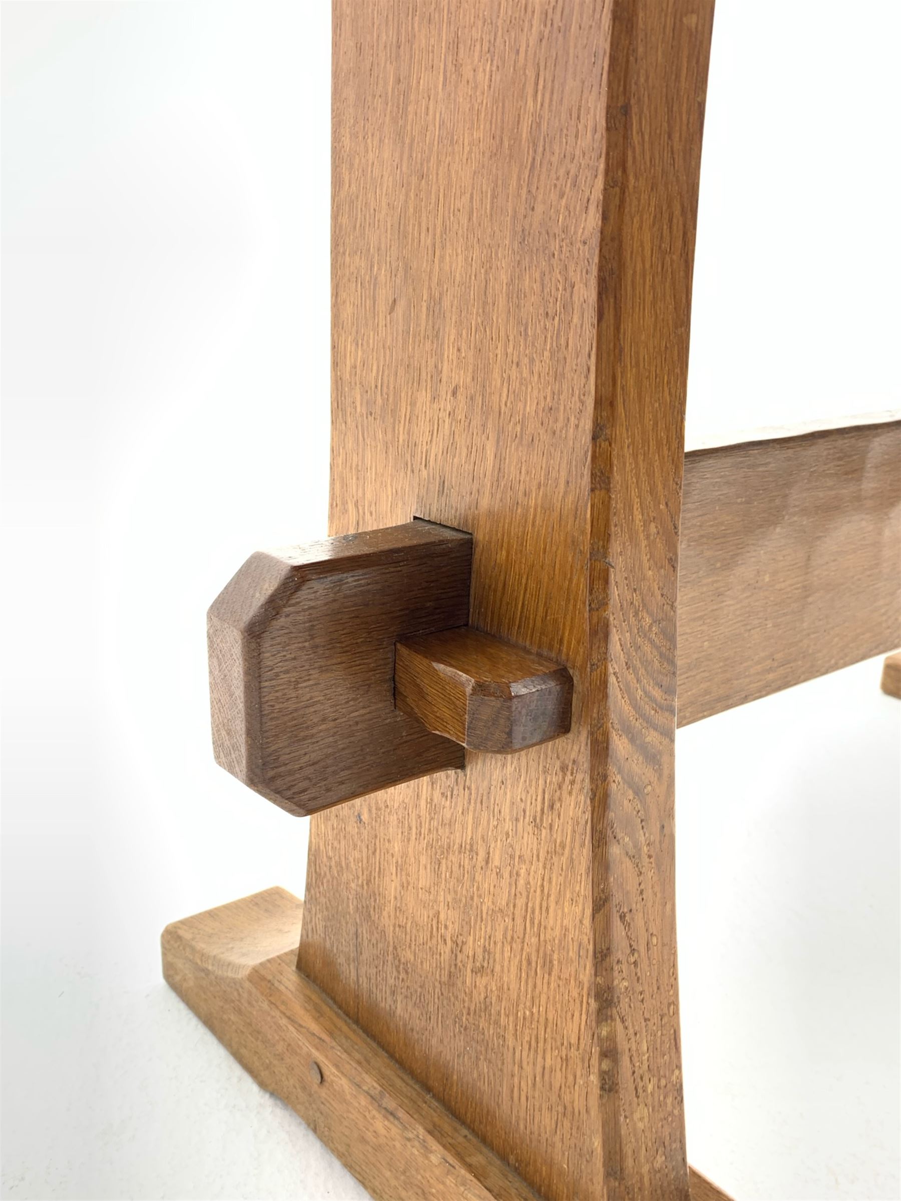 'Acornman' oak table with rectangular adzed top, shaped end supports on sledge feet joined by pegged stretcher carved with acorn signature, by Alan Grainger of Brandsby, York