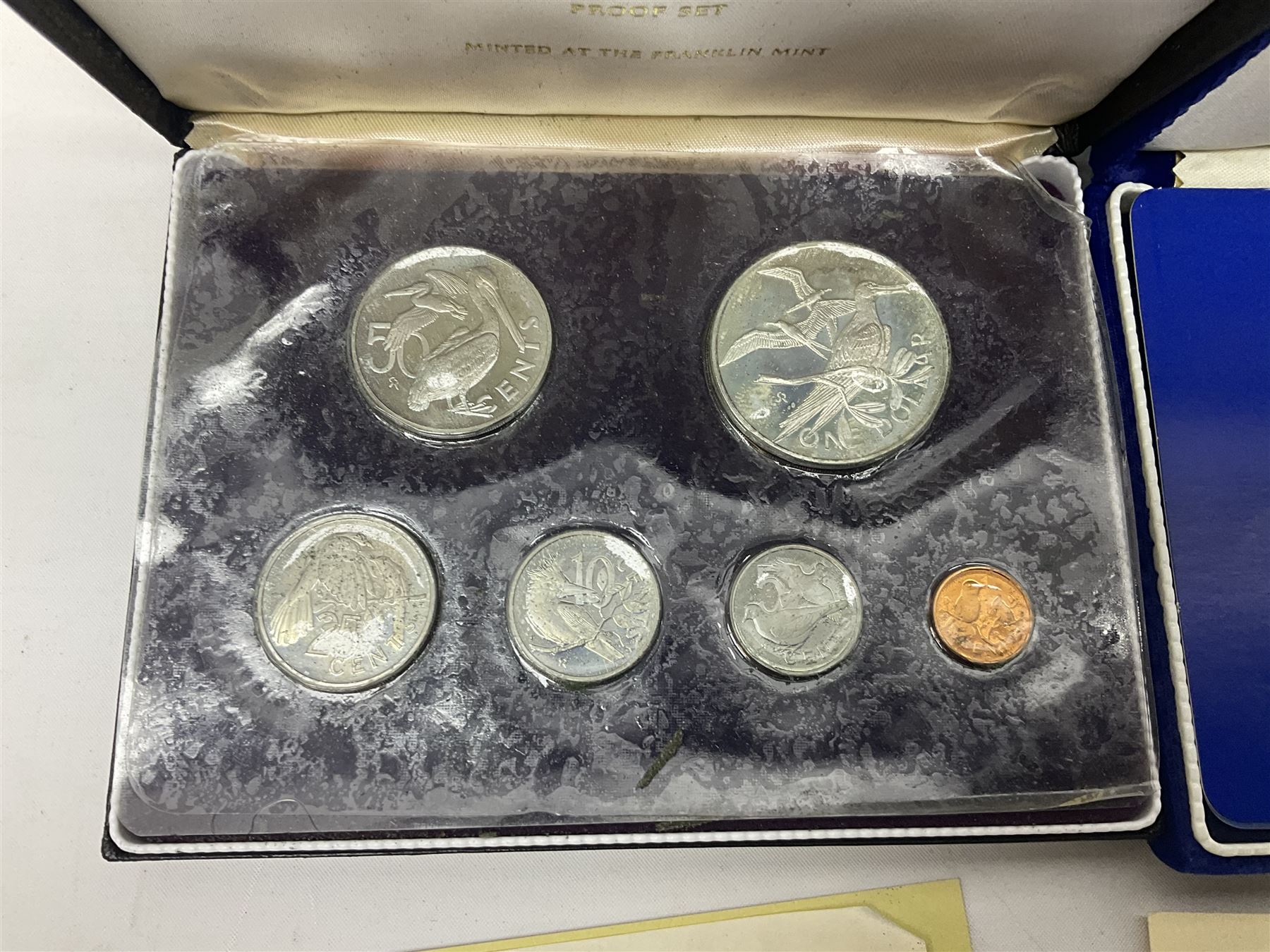 Four British Virgin Islands proof coin sets, comprising First Coinage of the British Virgin Islands 1973 proof six coin set, containing silver one dollar coin, 1977 and 1979 proof sets, containing high denomination silver coins, and The Royal Coronation Jubilee 1977 six coin silver proof set, each minted at the Franklin Mint, all cased with certificates, and a Solomon Islands 1978 proof seven coin set, containing silver five dollar coin, minted at the Franklin Mint, cased with certificate (5)