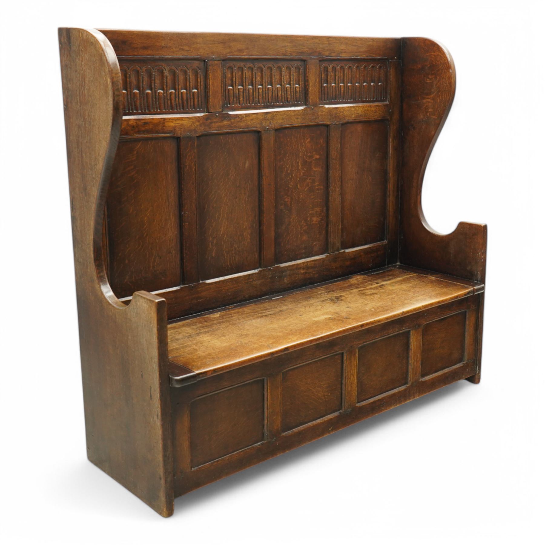 18th century design oak hall bench or settle, tall panelled back decorated with carved arcade, on two shaped end supports, hinged box seat opening to reveal a storage compartment, on a panelled base