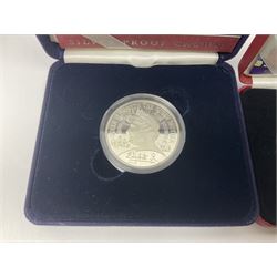 Queen Elizabeth II 2000 'The Queen Mother' silver proof five pound coin, 2000 'Millennium' silver proof five pounds, 2007 'Scouts' silver proof fifty pence, Tristan Da Cunha 2014 9ct gold 1 gram gold one crown coin, all cased with certificates and a 'Prince Charles 60th Birthday Commemorative Coin Cover' containing a 2008 silver proof five pound coin in folder (5)