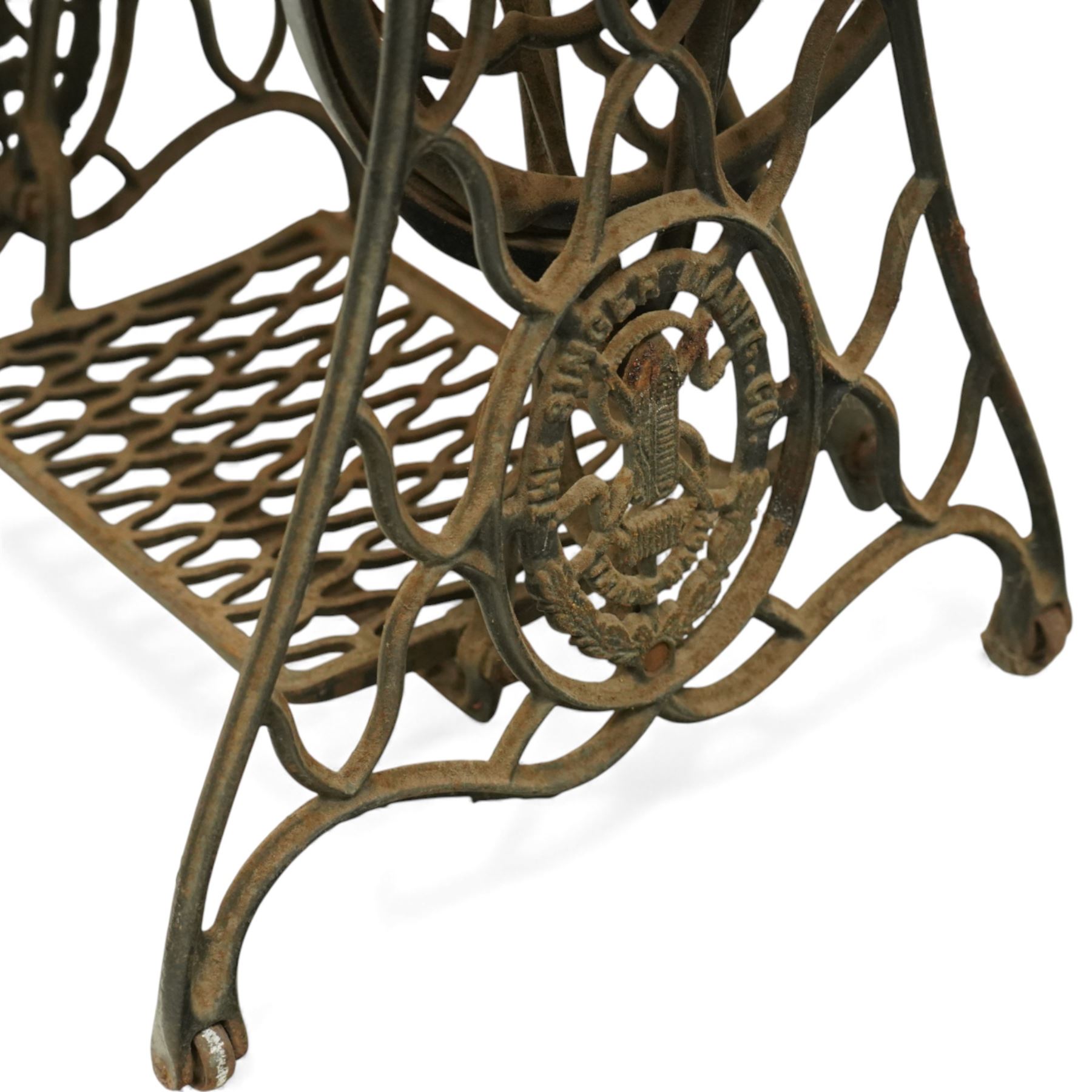 Early 20th century Singer treadle sewing machine, the black enamel machine with gilt floral and scroll transferwork set within a timber cabinet top with folding leaf, raised on cast-iron base with pierced geometric treadle and 'Singer' name stretcher, flanked by two small drawers