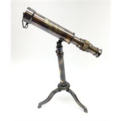 A small brass telescope mounted on an extending tripod base with folding feet, inscribed W Ottway & Co Ltd, Ealing London, 1915, H27cm.