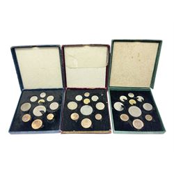 Three King George VI 1951 'Festival Of Britain' specimen coin sets, each comprising farthing to crown coins, housed in maroon, green and blue dated boxes 
