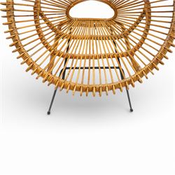 Janine Abraham and Dirk Jan Rol - Mid 20th century rattan sun lounger chair, circular openwork seat and back formed of radiating cane spindles with looped rim, raised on slender black metal tripod supports