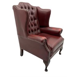Georgian style wing back armchair, upholstered in buttoned red leather