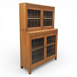 Early 20th-century Arts and Crafts glazed oak bookcase, upper section fitted with a pair o...