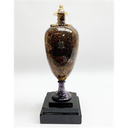 Early 19th century and later Blue John urn, Winnats one vein, of ovoid form with integrated cover and ball finial, upon a spreading circular base, and square stepped black lacquered base, H34.5cm