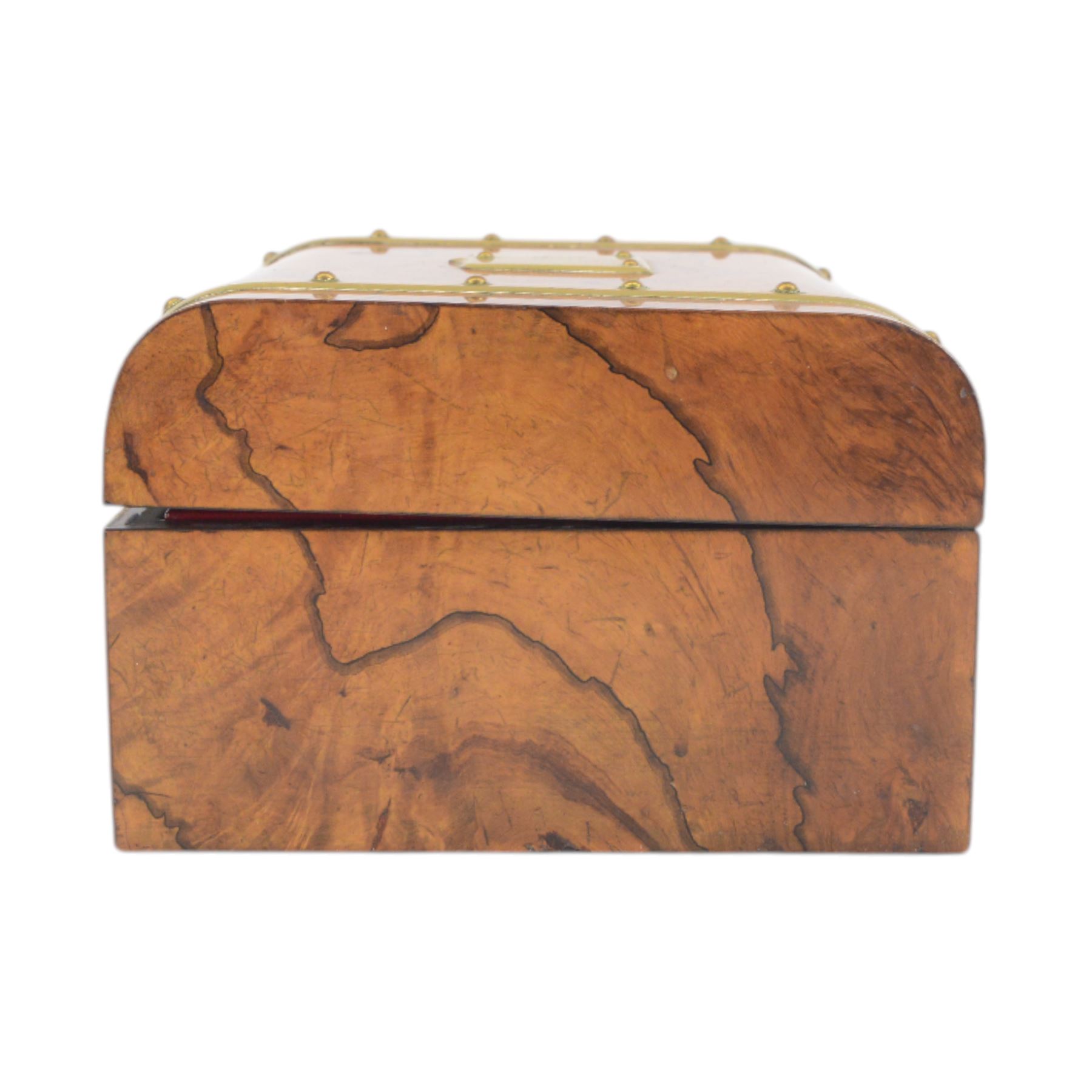 19th century walnut and brass bound games compendium box, painted to enhance the grain, of rectangular form, the hinged opening cover with rounded sides, central brass cartouche with engraved lion crest, and brass riveted straps, opening to reveal a red leather and blue silk lined compartmented interior, with fold-down games board, and lift-out tray containing playing cards, ebony turned dice towers, white and red stained bone draughts, and chess pieces, ivory dice, and ivory and ebony whist markers, and brass bezique board, cribbage board and markers, H15cm W32cm D24cm
This lot has been registered for sale under Section 10 of the APHA Ivory Act