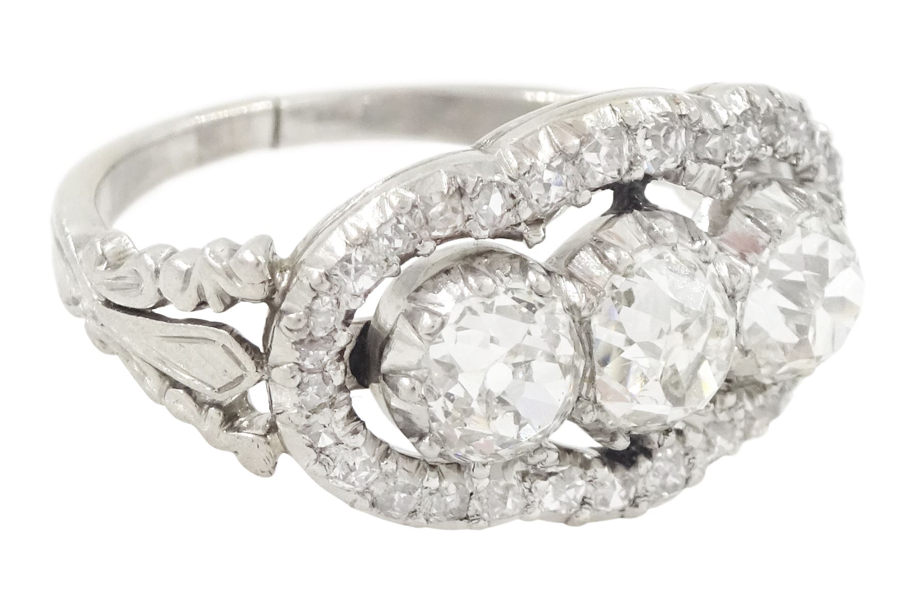 Late 19th / early 20th century platinum diamond ring, three old cut diamonds, in an openwork setting surrounded by further old cut diamonds, with pierced design shoulders, principal three diamonds total weight approx 1.45 carat, in a velvet and silk lined box by Selfridges