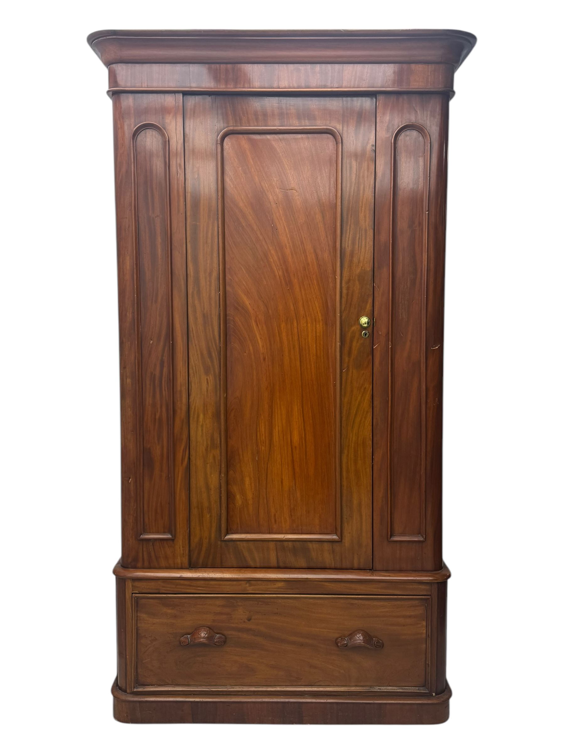 Large Victorian mahogany wardrobe, projecting moulded cornice over single panelled door enclosing hanging hooks and sliding rail, the base fitted with full width drawer, on plinth base

