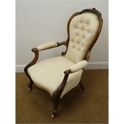  Victorian walnut framed spoon back armchair, carved cresting rail, upholstered in buttoned beige fabric, serpentine fronted seat, cabriole legs on castors (W63cm) and an oak framed armchair upholstered in matching material (W63cm) (2)  