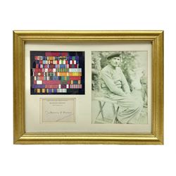 Montgomery (Bernard Law, 1887-1976). British Field Marshal of WW2 and Viscount of Alamein - signed titled signature card 'Montgomery of Alamein', professionally mounted and framed with representative rows of his ribbon bars and photographic print of him seated on a field stool; 29 x 38.5cm; gilt frame