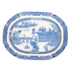 Pair of large 19th century blue and white platters, decorated in the Long Bridge pattern with pagodas, boats and figures, within a decorative border with scrolls, D39.5cm W52cm