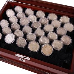 Thirty-two United States of America silver one dollar coins, comprising twenty-three 'Morgan' dollars and nine 'Peace' dollars, presented as 'The Complete Morgan and Peace Silver Dollar Collection', in display case