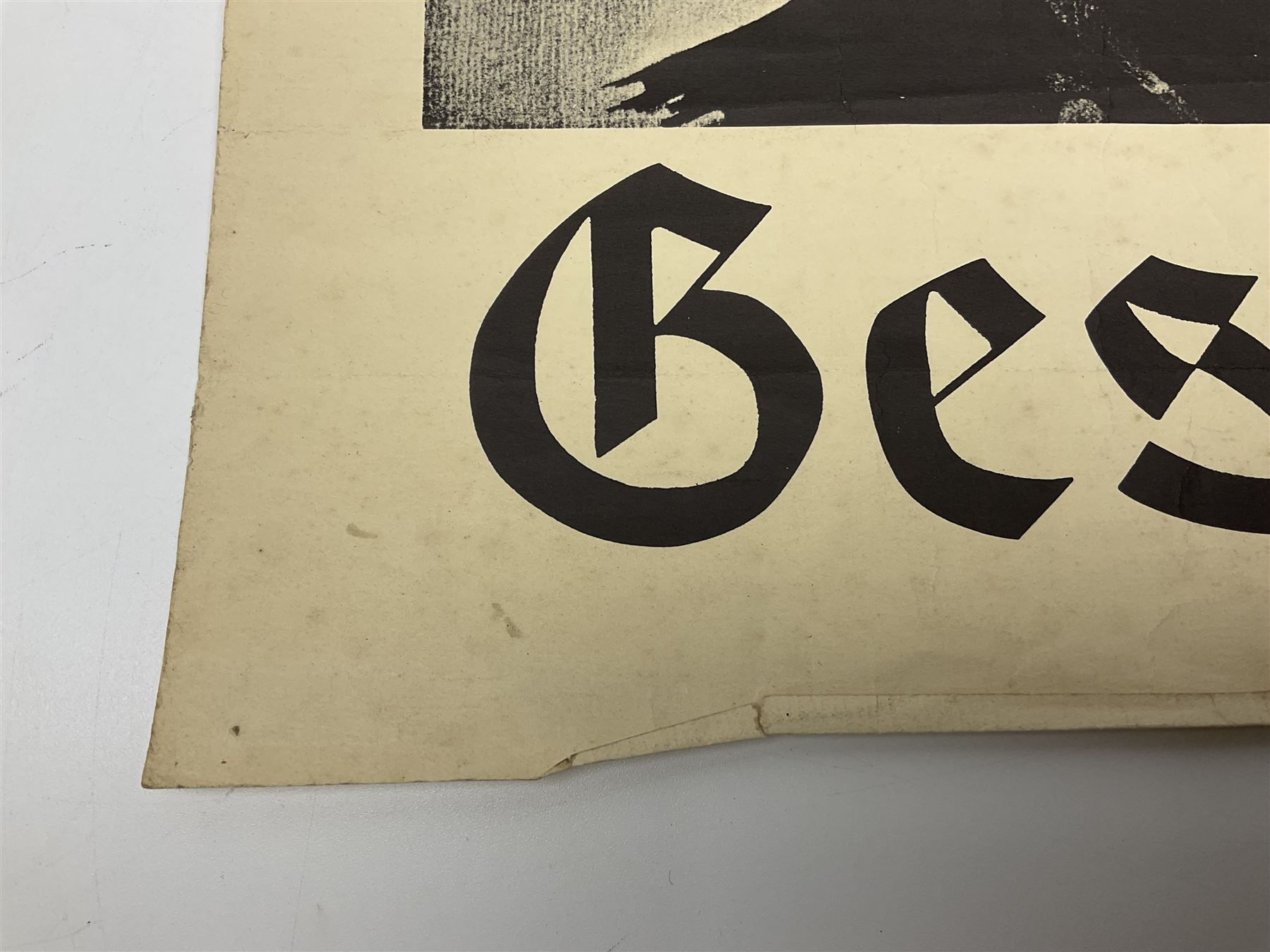 German monochrome 'Gestapo' poster, probably post-WW2, depicting the head of a grim faced Gestapo officer in uniform 55 x 42cm; unframed