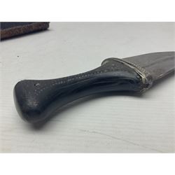Eastern Jambiya, the 19cm double edge steel blade with raised medial ridge, waisted horn grip with pique work and white metal band; in stitched leather scabbard L33cm overall
