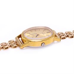 Omega ladies gold-plated quartz wristwatch, gilt dial with baton hour markers, on 9ct gold bracelet, Birmingham 1977, boxed with original leather strap