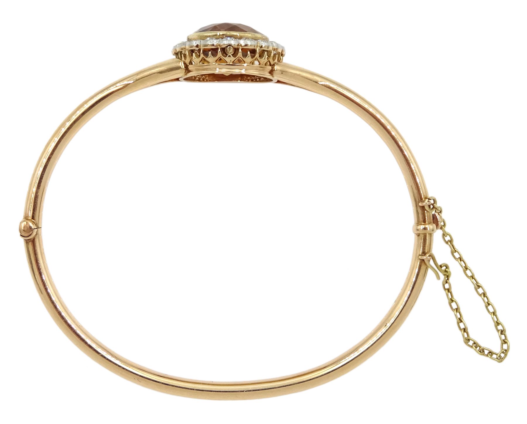 Early 20th century 15ct rose gold oval citrine and milgrain set old cut diamond hinged bangle, total diamond weight approx 1.10 carat