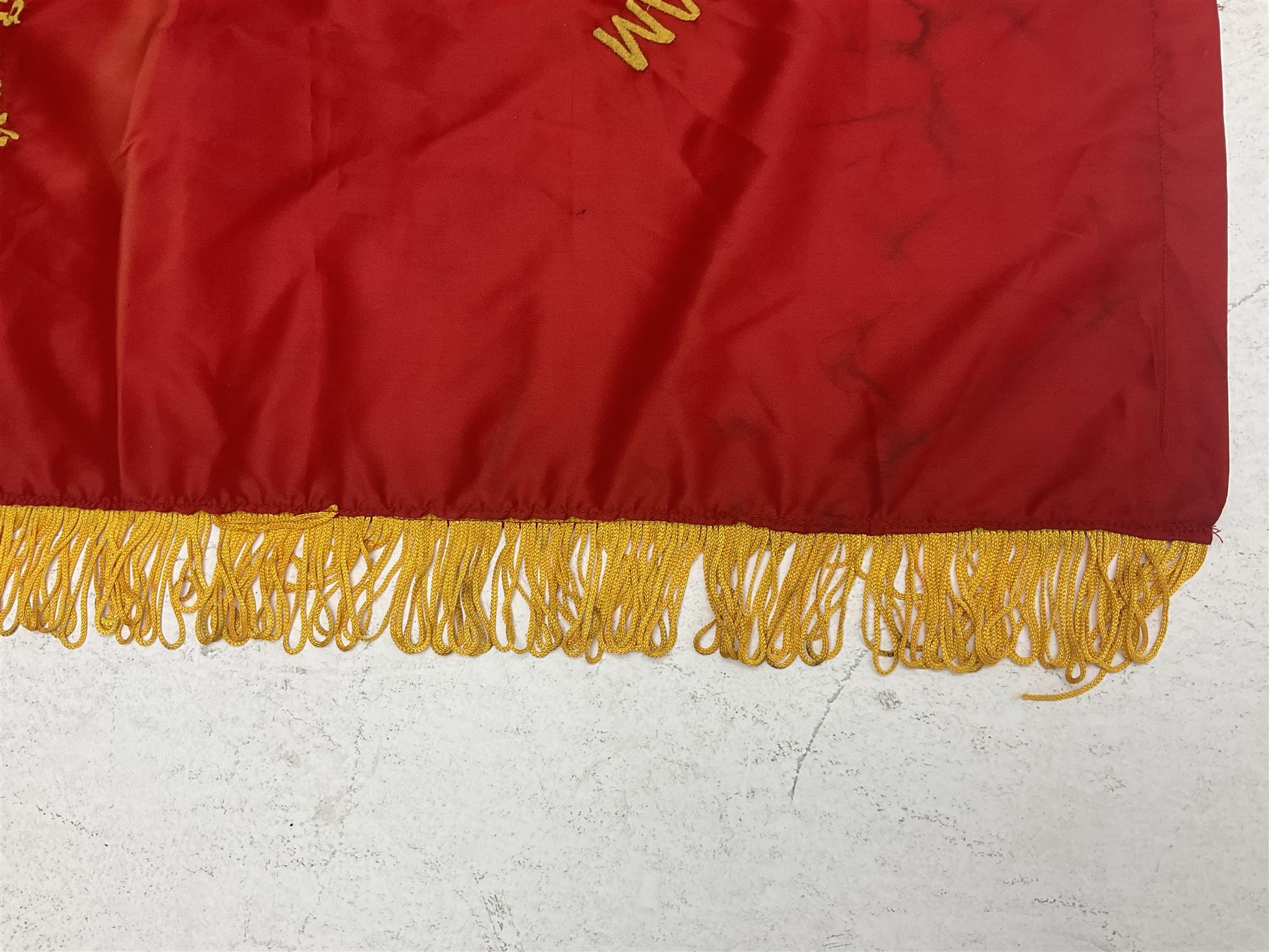 1960s North Vietnam banner embroidered in yellow thread on a red ground, roughly translates as 'Peoples Army of Viet Nam. Warriors of Viet Nam Determined To Keep The Country 1964' around a central military crest with the motto 'Warriors Keep The Country'; tassels to three sides 70 x 100cm