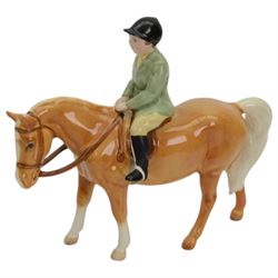 Two Beswick figures, comprising Boy on palomino pony no 1500 and Thelwell Angel on Horseback