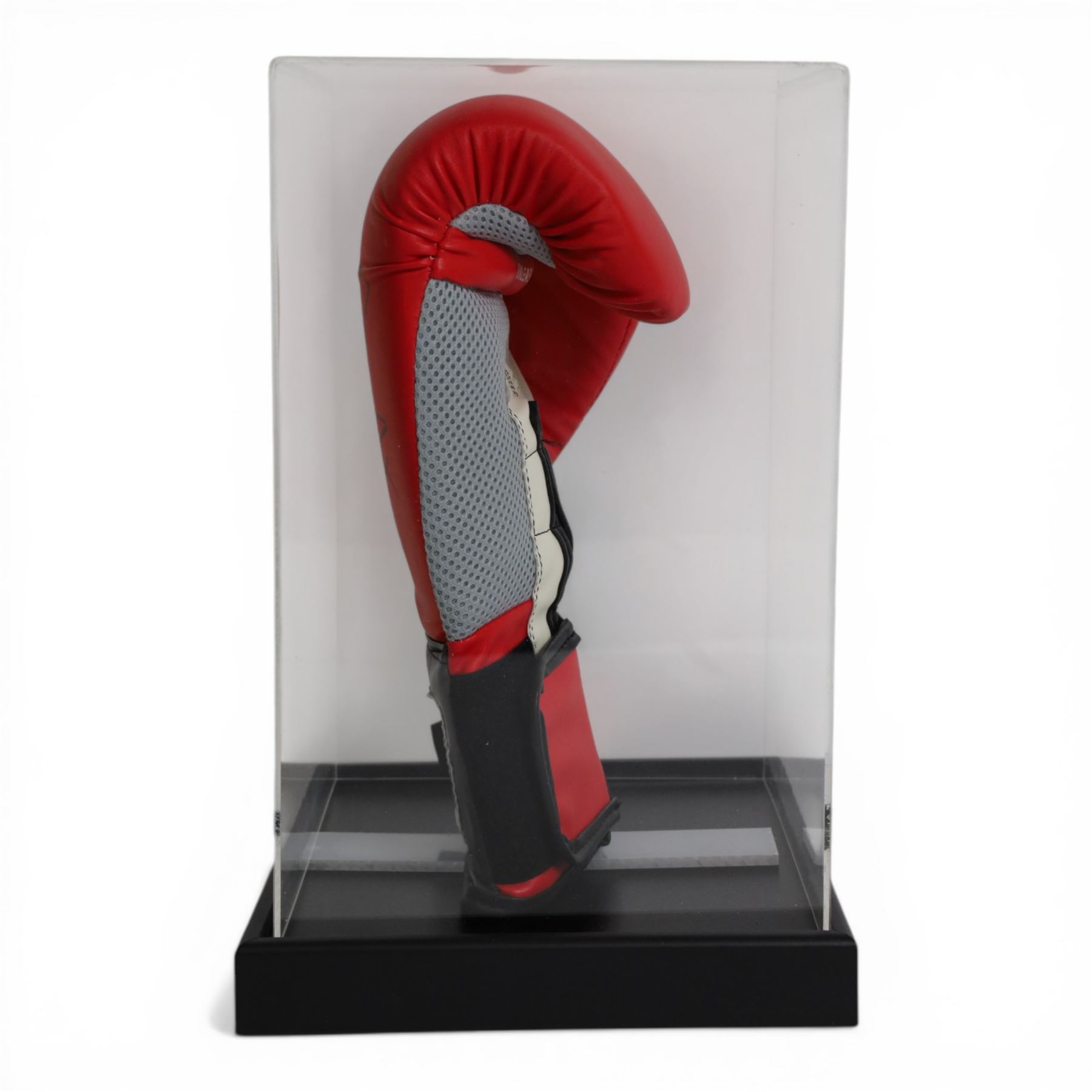 Lonsdale boxing glove, signed by Nigel Benn in black marker pen, in acrylic display box