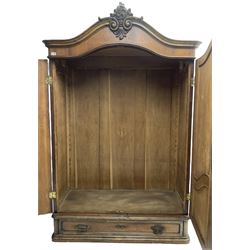 Late 19th century to early 20th century French walnut armoire wardrobe, the shaped pediment carved with shell C-scroll with extending scrolled foliage decoration, enclosed by two doors with shaped and figured panels, fitted with single drawer to base