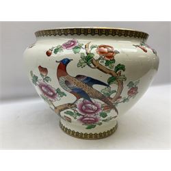 Large ceramic Jardiniere on stand, decorated with an oriental pheasant perched upon branches blossoming with peonies and foliage on white ground, overall H99cm