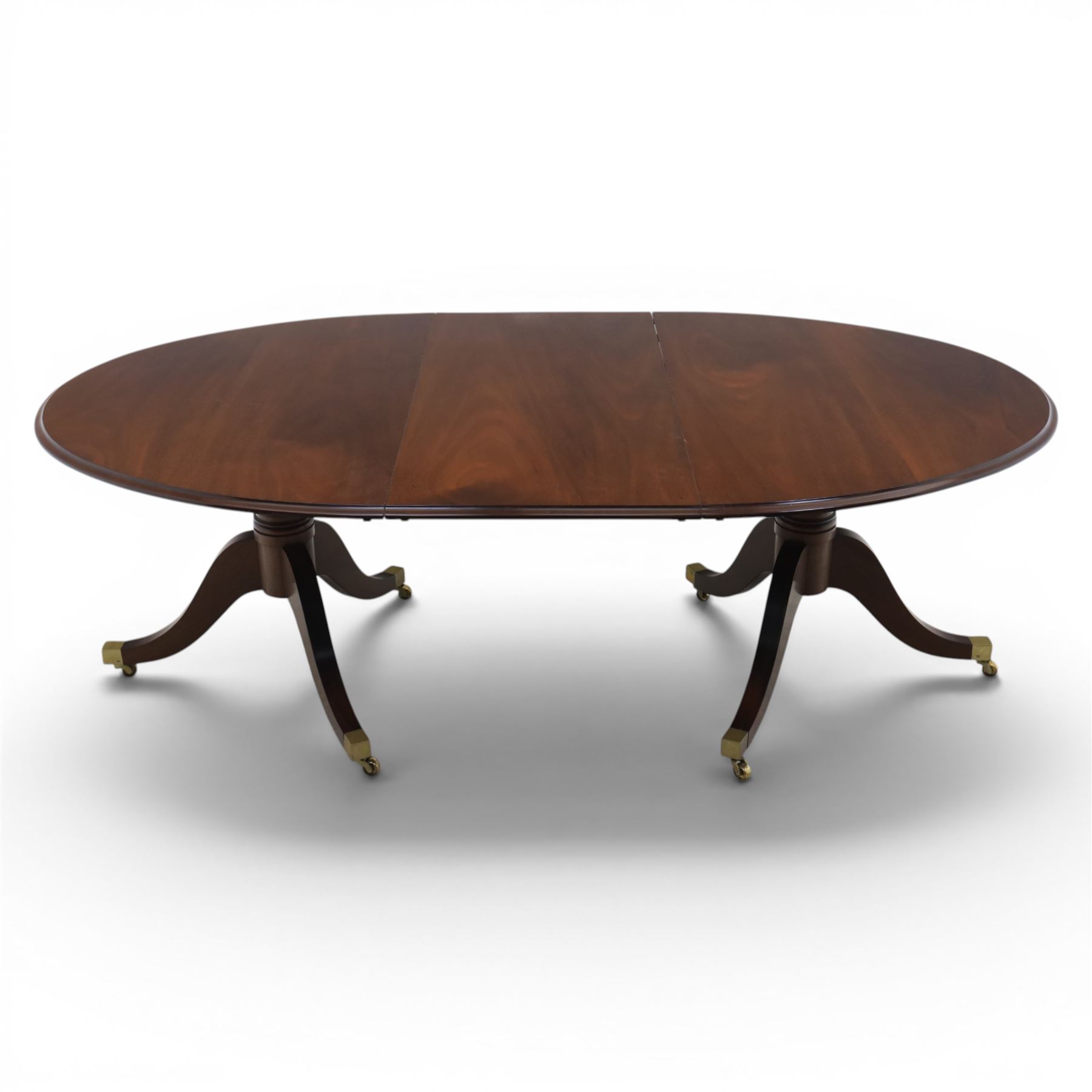 Gott's Pickering - Quality Georgian design rosewood twin pillar extending dining table, with additional leaf, oval form raised on turned columns with tripod legs on cast brass sockets and castors, complete with brass coupling forks, length 164cm without leaf