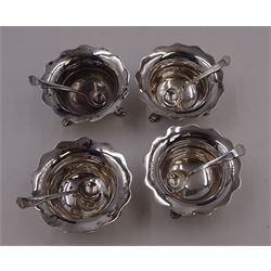 Set of four Edwardian silver open salts, of circular form, each with later personal engraving to scalloped rim and upon three pad feet, together with four matching silver salt spoons, hallmarked James Deakin & Sons, Sheffield 1909, in velvet and silk lined fitted case     